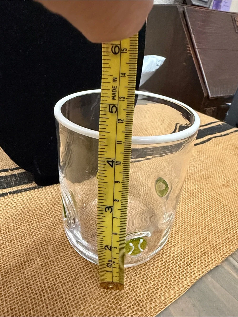 Anthropologie Clear drinking glass with yellow/green tennis ball accents.